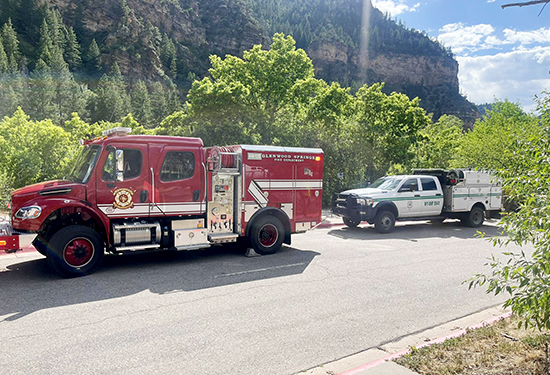 A U.S. Forest Service truck and a Glenwood Springs Fire Department fire truck on the scene of a brush fire in Glenwood Canyon, near Glenwood Springs, CO.