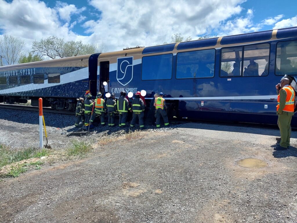 Local fire officials next to the train that collided with a tanker truck near Rifle on May 6.