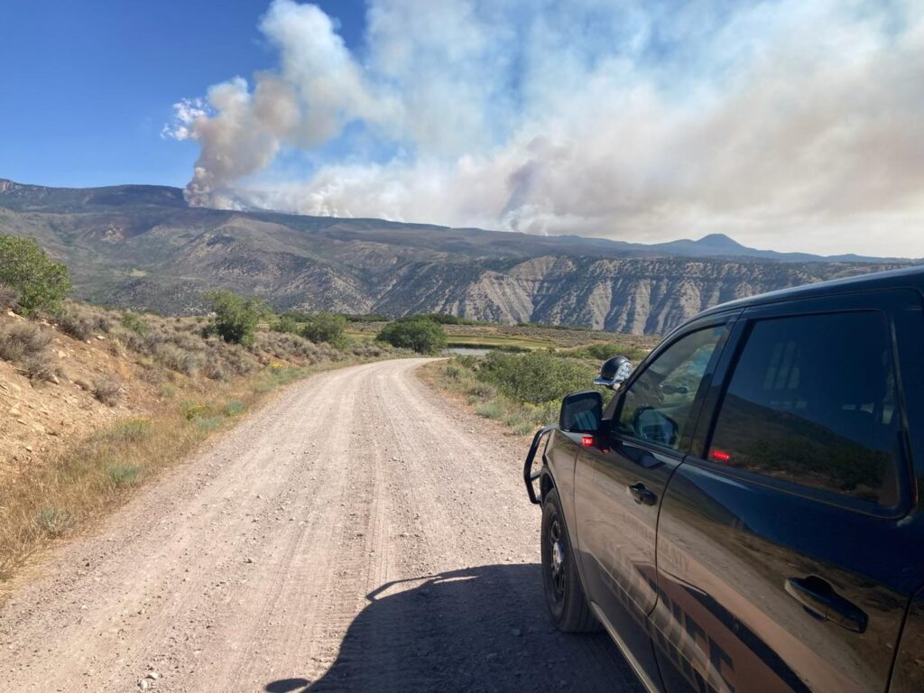 Garfield county sheriff's vehicle with Derby fire in background