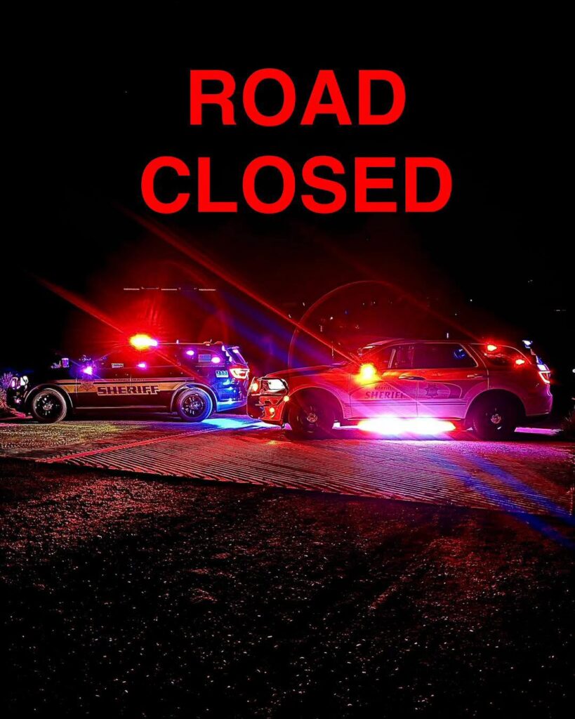 Garfield County Sheriff's Office road closure notice displaying two GCSO vehicles with flashing lights. 